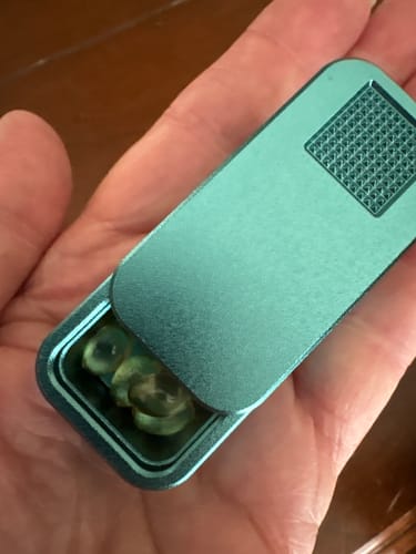 Customer holding the open, teal Secret Menu Single Case in their palm.