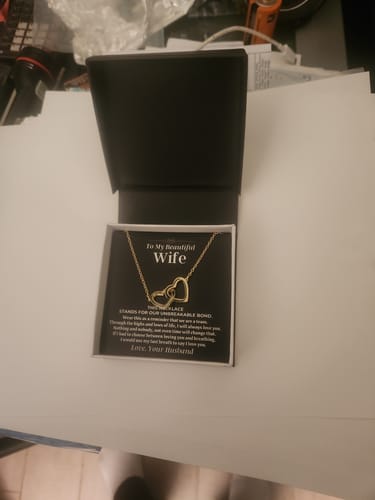 Customer's Forever Linked Hearts necklace in its open black gift box with a message card.