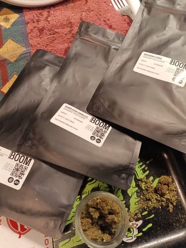 Customer's pouches of Wedding Cake (Oz) on a table, with some ground product in a small jar and on a tray.