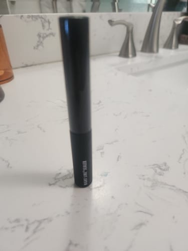 Customer's black Night Line® Sealer tube standing on a white marble bathroom counter.