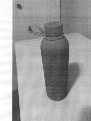 Customer's grainy, black and white photo of their LOGiiX VIBRANCE Water Bottle standing on a counter.