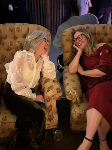 Reviewer at a wedding wearing the Sheer Embroidered Floral Shirt with olive green velour trousers.
