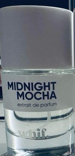 Customer's close-up of the clear glass Midnight Mocha perfume bottle with a light purple cap.