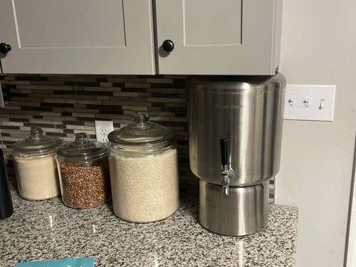 Customer's stainless steel Glacier Fresh water filter system sitting on a kitchen counter under a cabinet.