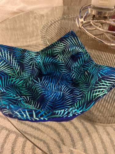 Customer's handmade bowl cosy showing the Tropical Fern Leaves fabric with a blue and green pattern.