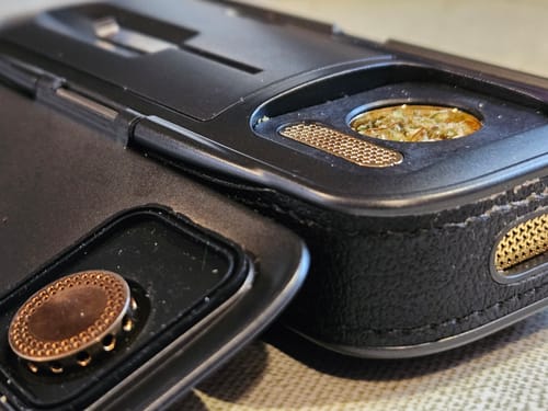 Close-up of a customer's black Legacy PRO 2, showing the loaded chamber and bronze accents.