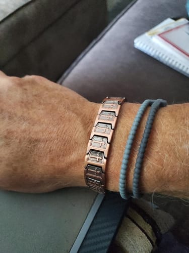 Customer wearing the Templar Cross Copper Magnetic Bracelet, showing the detailed cross design on its links.