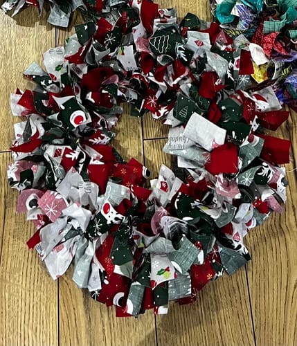 Reviewer's festive wreath made with strips of the White Reindeer Faces Polycotton Fabric and other prints.