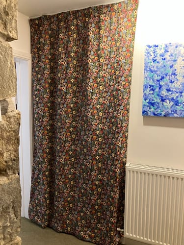 Customer's Kew Gardens Tapestry Fabric used as a long, colorful curtain hanging in a doorway.