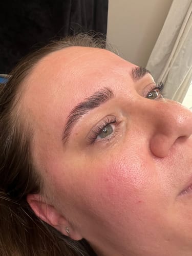 Reviewer showing a close-up of their freshly laminated eyebrow after using the My Lamination cream.