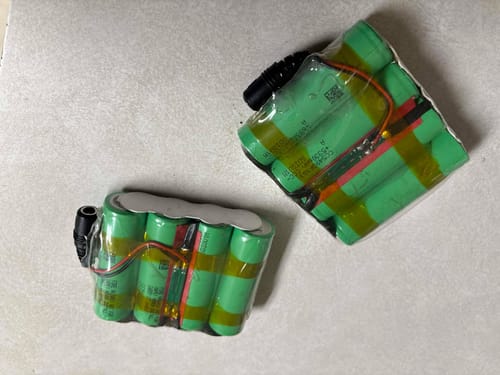 Reviewer's two custom battery packs for heated gloves, built using multiple green Samsung 58E batteries.