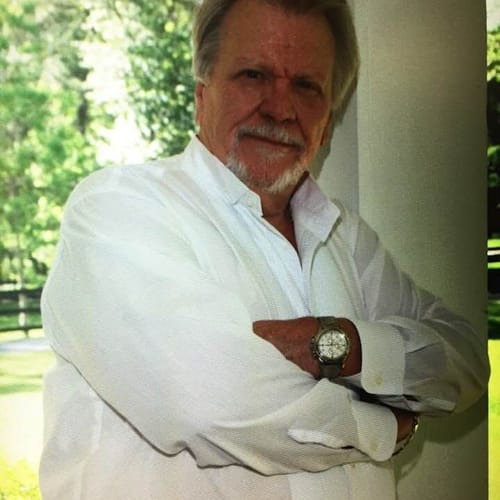 Reviewer in a white shirt with arms crossed, submitted with a review for Performance Eucalyptus Compression Socks.