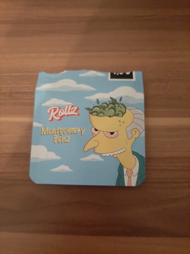 Packaging for the reviewer's Montgomery Benz THCA Flower, a blue pouch with a cartoon character.