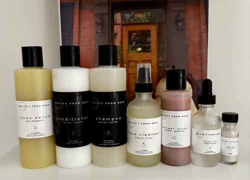 Reviewer's Face Oil in a dropper bottle, shown as part of their full collection of skincare and haircare products.