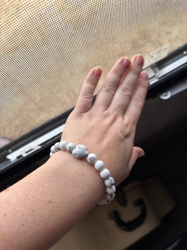 Reviewer showing off their white beaded crystal bracelet on their wrist.