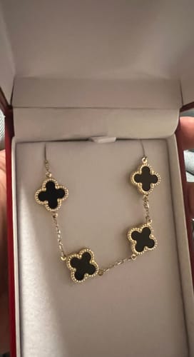 Customer's 14K Black Clover Fancy Bracelet with four black stone charms displayed in its jewelry box.