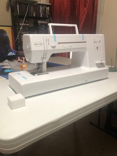 Customer's new Baby Lock Jazz 2 sewing machine set up on a white table.