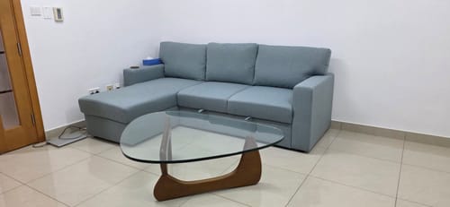 Customer's Noguchi Solid Wood Coffee Table with a glass top and walnut base in a living room setting.
