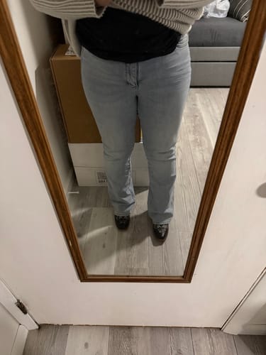 Customer wearing the light wash Judy Blue High-Waist Tummy Control Bootcut Jeans, seen from the front in a mirror selfie.