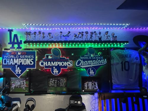 Reviewer's illuminated Los Angeles Dodgers metal wall art displayed in a fan cave with other team memorabilia.
