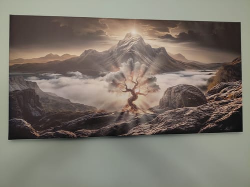 Customer's Tailored Boost canvas print hanging on a wall, showing a glowing tree in a dramatic mountain landscape.