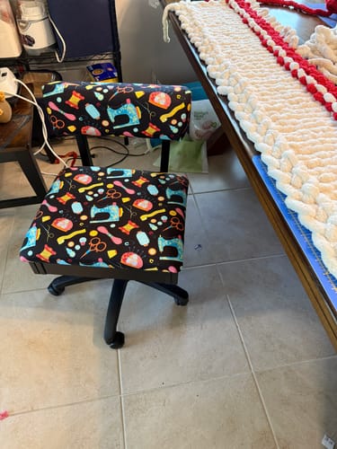 Customer's Arrow Hydraulic Sewing Chair with a colorful sewing-themed pattern, shown assembled on a tile floor.