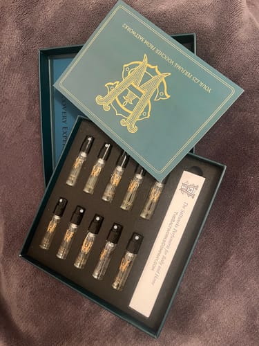 Reviewer's open Discovery Set box showing the ten small perfume vials arranged inside.