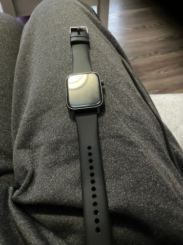 Customer's Gard Pro Health Smartwatch 2+ with a black band resting on their lap.
