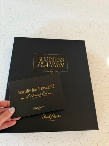 Customer showing the packaging for the 2026 Business Planner and an inspirational card.