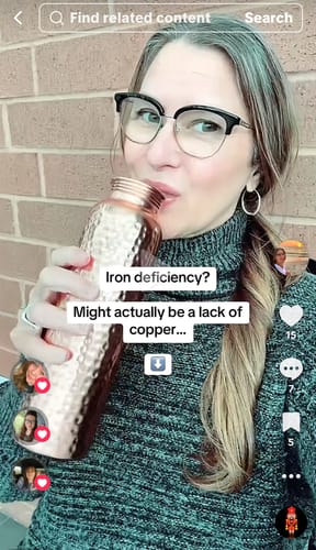 Reviewer drinking from a hammered Himalayan Ayurvedic Pure Copper Bottle.