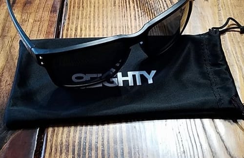 Customer's black 80Eighty Polarized Sunglasses resting on the included black microfiber bag.
