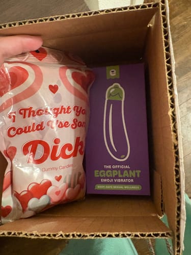 Customer's 'Take the Hint' Valentine’s Bundle inside a cardboard box, showing the packaged vibrator and gummy candies.