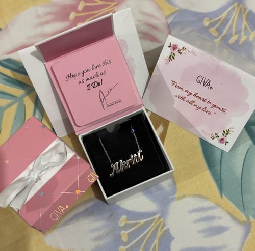 Customer's Silver Evil Eye Personalised Name Necklace displayed inside its elegant pink gift box with accompanying cards.