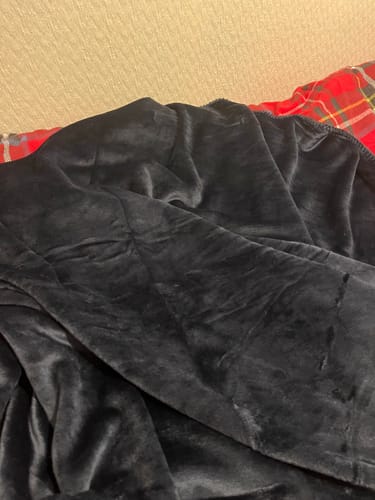 Reviewer's close-up of the navy supersoft fleece blanket, showing its plush texture.
