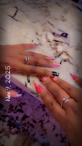 Reviewer's two hands, each wearing a silver Hug Ring against a marble-like surface.