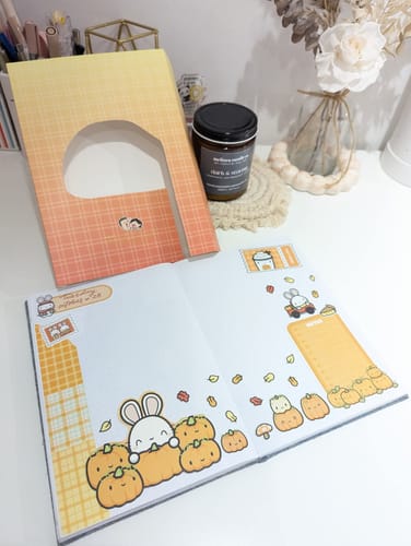 Reviewer's journal decorated with cute stickers from the Autumn Bunnies Box Set, with the set's paper sleeve packaging on the desk.