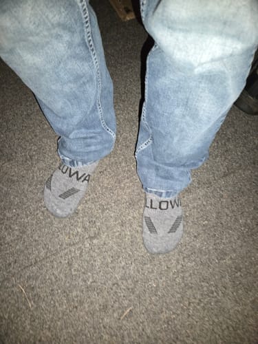 Customer shows wear and pilling on their grey Alpaca Socks after one use.