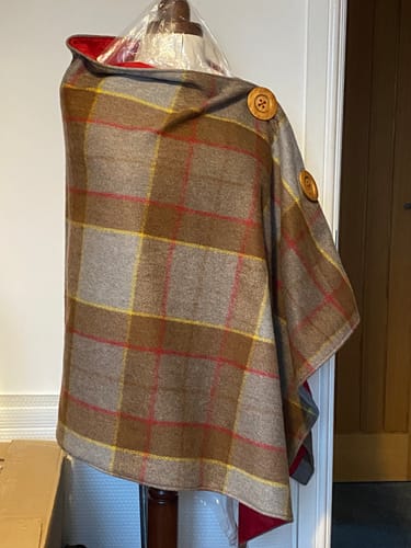 Reviewer's tartan shawl on a mannequin, lined with a bright red Plain Polycotton Fabric.