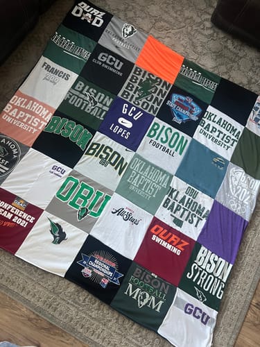 Customer's finished Premium T Shirt Quilt made from various school and sports team t-shirts.