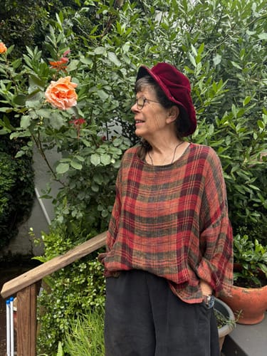 Reviewer outdoors wearing the loose, plaid O-Neck Ramie Shirt.
