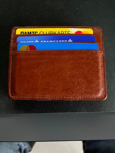 Reviewer's brown leather Flap Boy Slim wallet with several cards neatly placed in the slots.