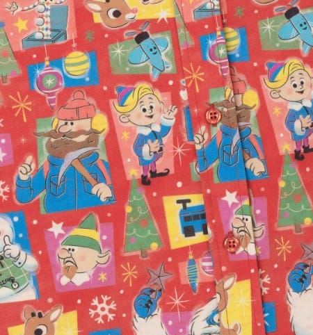 Close-up of the reviewer's red "Christmas ‘64" shirt, showing the colorful pattern of Rudolph characters.