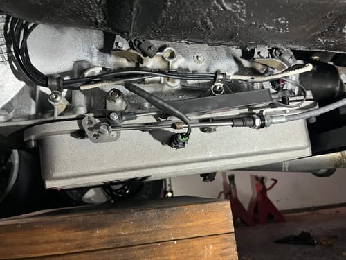 Customer's Operator Shift Position Sensor Kit installed on the side of a vehicle's transmission, viewed from underneath.