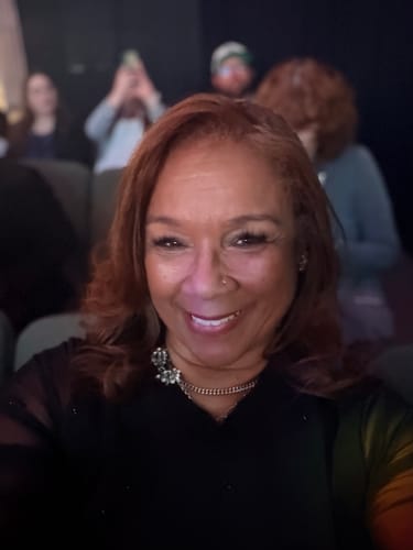 Customer showing off her vibrant reddish-brown hair after using the Instant Dye Shampoo.