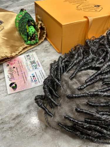 Customer's Distressed Locs Wig in gray and black, shown with the product box and a thank you card on a table.