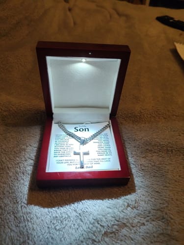 Customer's Artisan Cross on Cuban Link Chain gift set in its open, illuminated mahogany box.