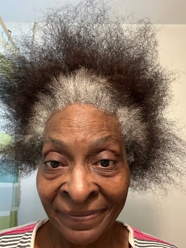 Reviewer showing her hair with prominent gray roots before using the hair dye.