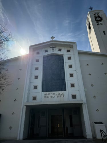 Customer photo of the front of a white church building against a bright, sunny sky.