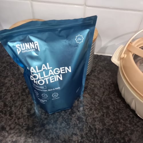 Customer's blue pouch of Sunna Supplements Halal Collagen Protein resting on a dark kitchen counter.