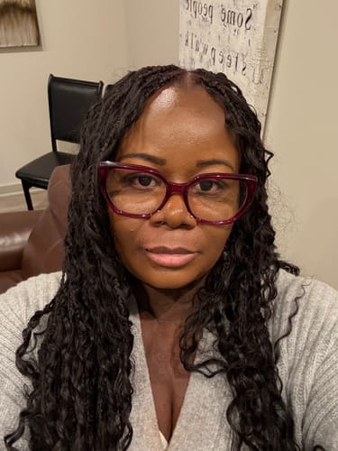 Close-up of a reviewer wearing the Burmese Spanish Curl Human Braiding Hair styled into long, dark braids.